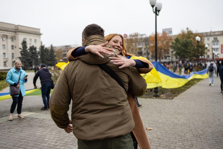 A local girl hugs Ukrainian soldier on Liberty Square during the celebration of the city's liberation on November 12, 2022 in Kherson, Ukraine.